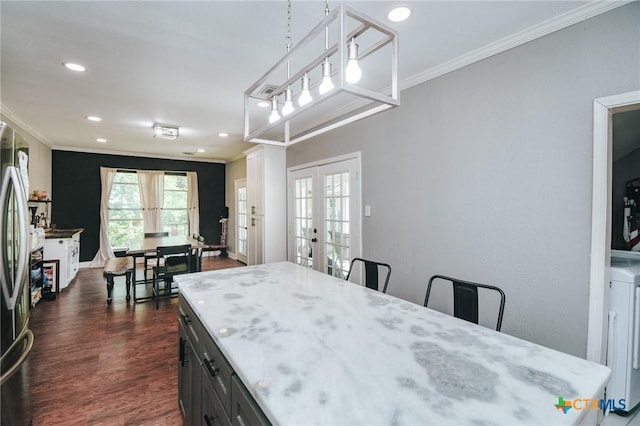 dining space with french doors, ornamental molding, dark wood-type flooring, and recessed lighting