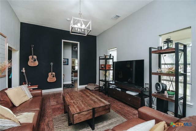 living area featuring visible vents, wood finished floors, a notable chandelier, and a wealth of natural light
