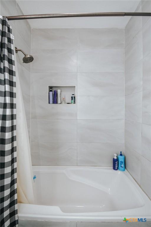 full bathroom with shower / bath combination with curtain