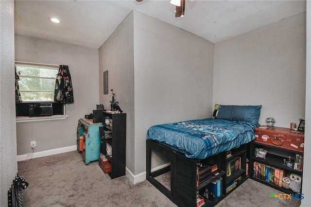 carpeted bedroom with a ceiling fan, baseboards, and cooling unit