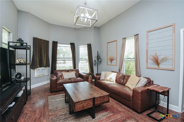living area with a healthy amount of sunlight, baseboards, and a chandelier