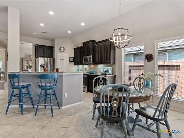 2136 Pioneer Pass, Seguin, TX 78155 - dining room with a chandelier, lofted ceiling, recessed lighting, light tile patterned floors, and baseboards