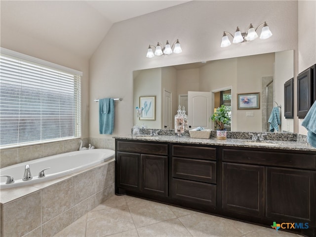 2136 Pioneer Pass, Seguin, TX 78155 - full bathroom featuring double vanity, a garden tub, tile patterned floors, a shower stall, and vaulted ceiling