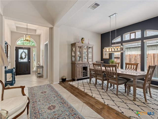 2136 Pioneer Pass, Seguin, TX 78155 - dining space featuring a chandelier, plenty of natural light, light tile patterned floors, and a high ceiling