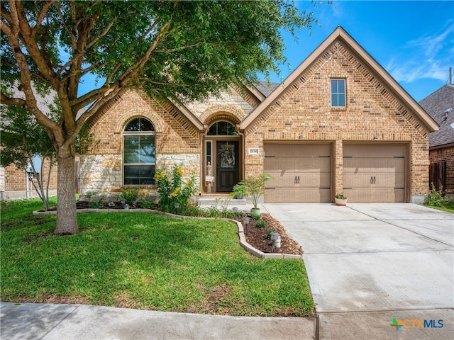 2136 Pioneer Pass, Seguin, TX 78155 - view of front facade featuring brick siding, a front yard, driveway, and an attached garage