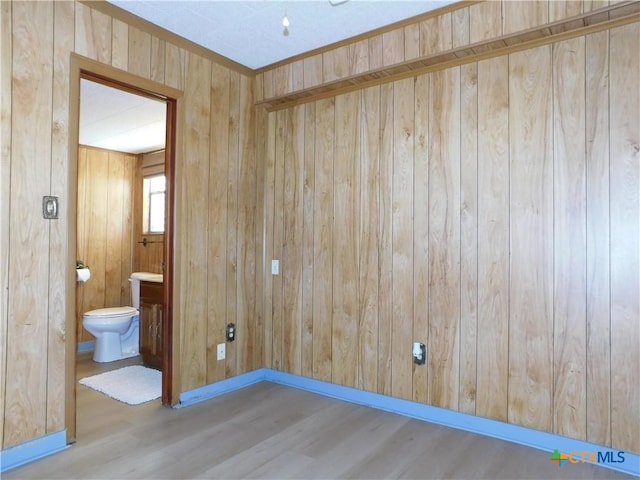 135 W Bayshore Dr, Palacios, TX 77465 - unfurnished room featuring wood finished floors, wooden walls, and baseboards