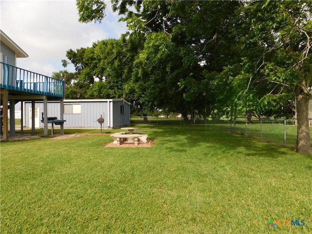 135 W Bayshore Dr, Palacios, TX 77465 - view of yard with a wooden deck and an outbuilding