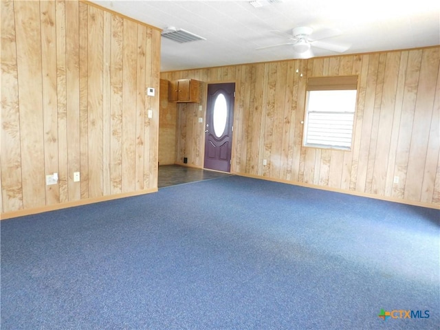 135 W Bayshore Dr, Palacios, TX 77465 - carpeted spare room featuring ceiling fan, wooden walls, and baseboards