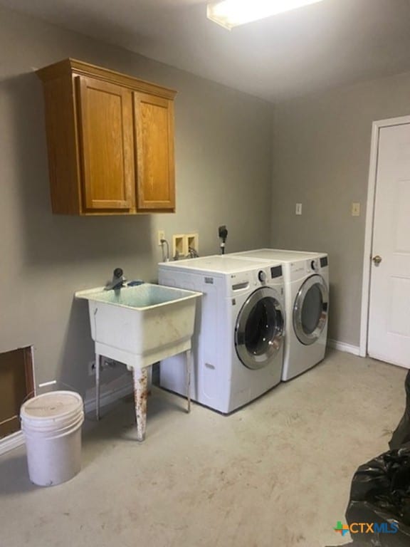 233 Thomas Dr, Martindale, TX 78655 - laundry area featuring cabinet space, independent washer and dryer, and baseboards