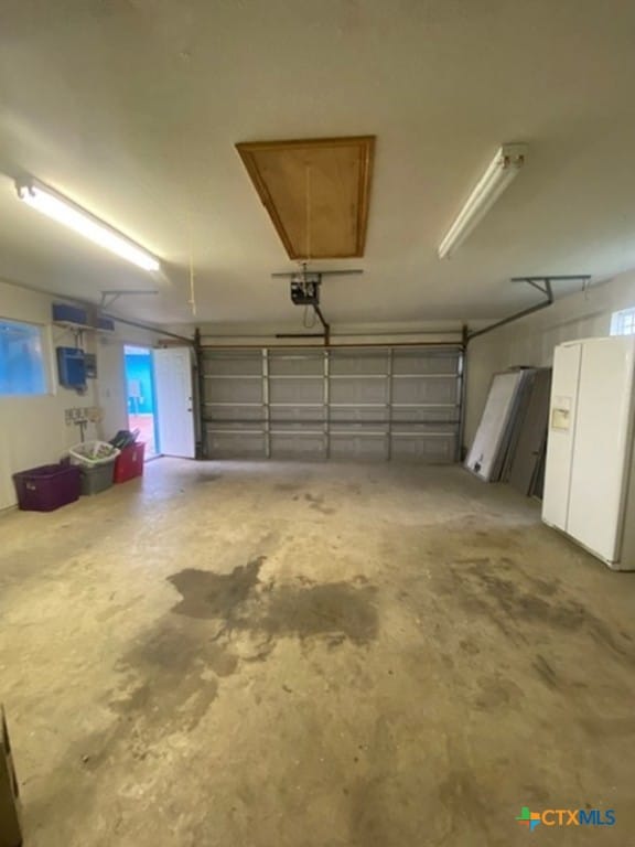 233 Thomas Dr, Martindale, TX 78655 - garage with white refrigerator with ice dispenser