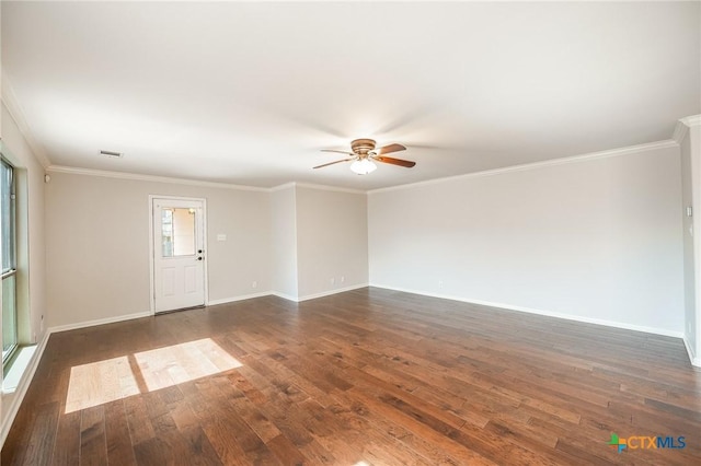 empty room with visible vents, ornamental molding, dark wood-style floors, baseboards, and ceiling fan