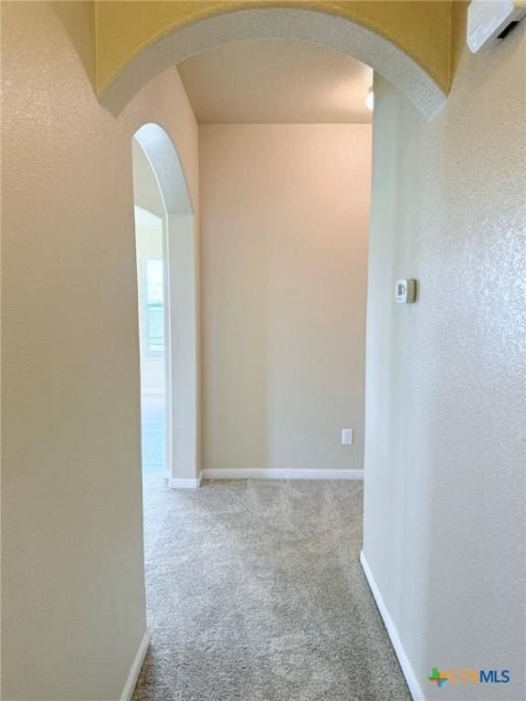 2602 Camp Cooper Dr, Killeen, TX 76549 - hall with carpet, baseboards, and arched walkways