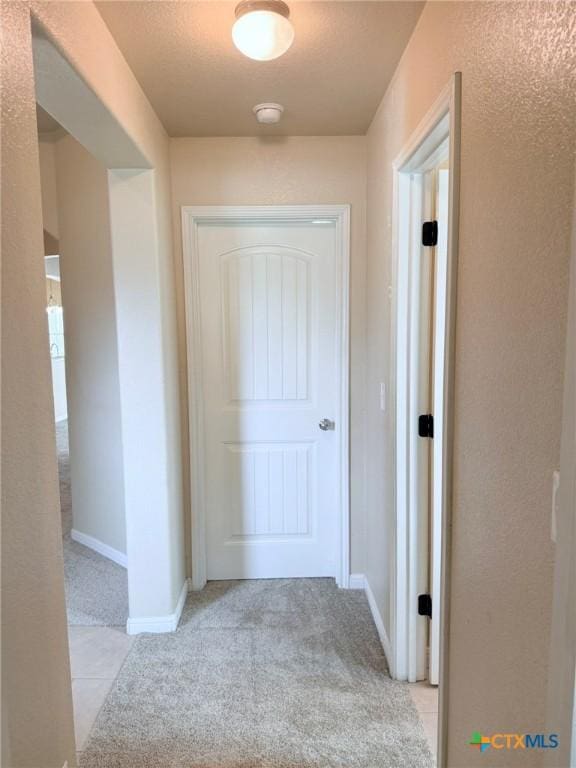 2602 Camp Cooper Dr, Killeen, TX 76549 - hall with light carpet, baseboards, and a textured wall