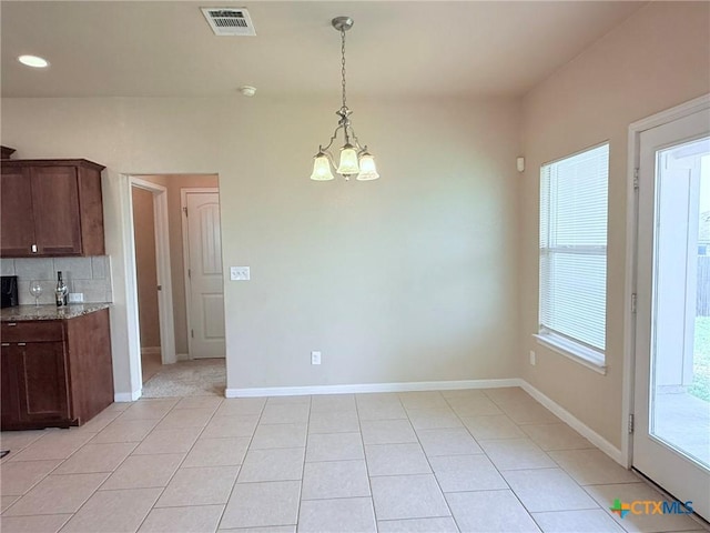 2602 Camp Cooper Dr, Killeen, TX 76549 - kitchen featuring a chandelier, light tile patterned floors, light stone countertops, decorative light fixtures, and tasteful backsplash