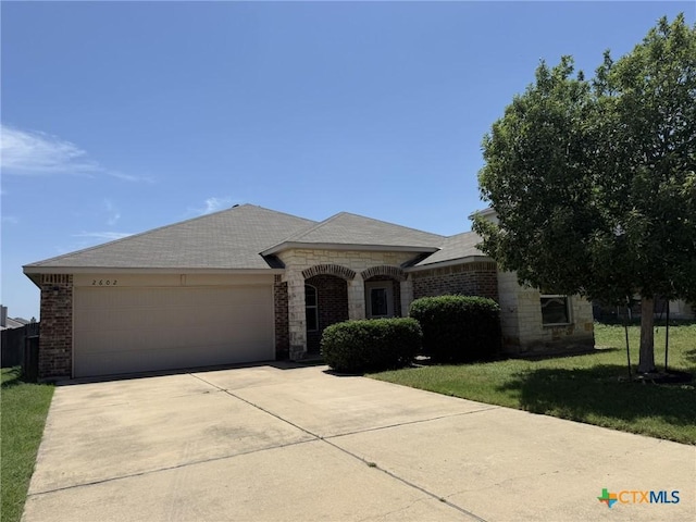 2602 Camp Cooper Dr, Killeen, TX 76549 - french country home with brick siding, an attached garage, driveway, and a front yard