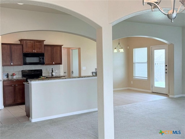 2602 Camp Cooper Dr, Killeen, TX 76549 - kitchen featuring black appliances, light colored carpet, a chandelier, and light tile patterned floors