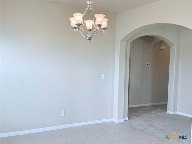 2602 Camp Cooper Dr, Killeen, TX 76549 - spare room featuring arched walkways, a chandelier, baseboards, and light tile patterned flooring