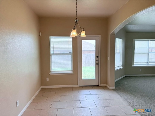 2602 Camp Cooper Dr, Killeen, TX 76549 - entryway with a chandelier, arched walkways, light tile patterned flooring, and baseboards