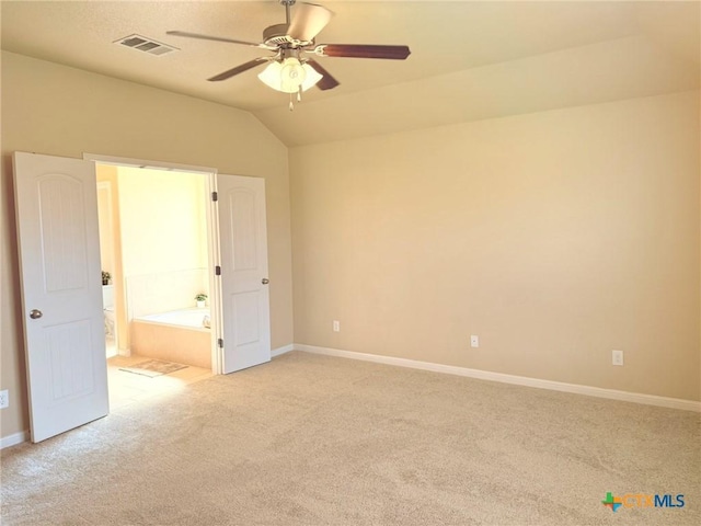 2602 Camp Cooper Dr, Killeen, TX 76549 - unfurnished bedroom featuring light colored carpet, baseboards, lofted ceiling, ensuite bath, and ceiling fan