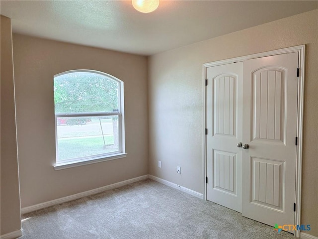 2602 Camp Cooper Dr, Killeen, TX 76549 - unfurnished bedroom featuring light colored carpet, a closet, and baseboards