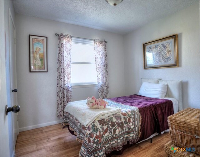 5110 Sam Houston, Temple, TX 76502 - bedroom with wood finished floors and a textured ceiling