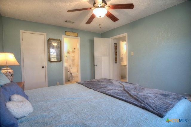 5110 Sam Houston, Temple, TX 76502 - bedroom featuring a textured ceiling, ensuite bath, and a ceiling fan