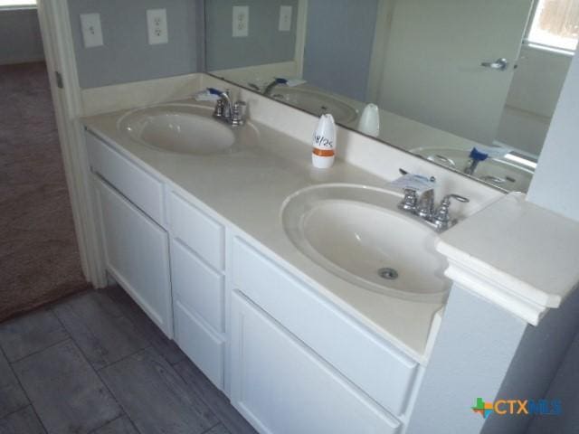 full bath featuring double vanity and a sink