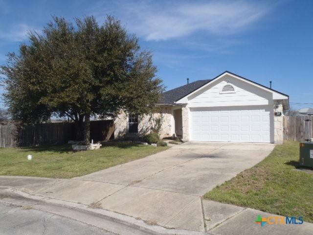 single story home featuring concrete driveway, an attached garage, fence, central air condition unit, and a front lawn