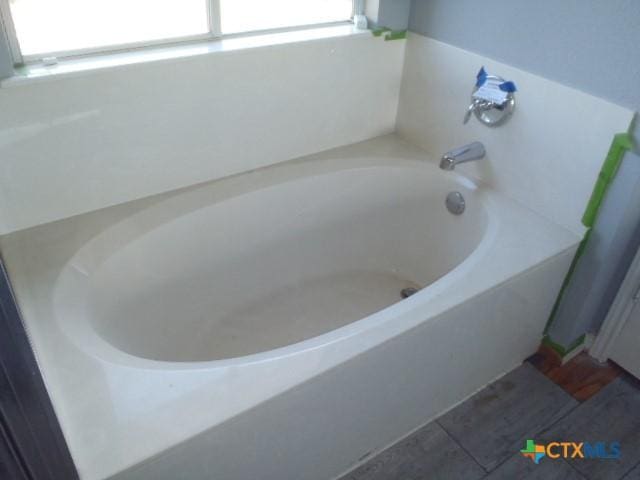 bathroom with a garden tub