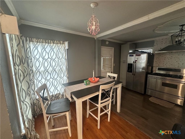 502 Tommy Dr, Port Lavaca, TX 77979 - dining room featuring dark wood-style floors, ornamental molding, and a chandelier