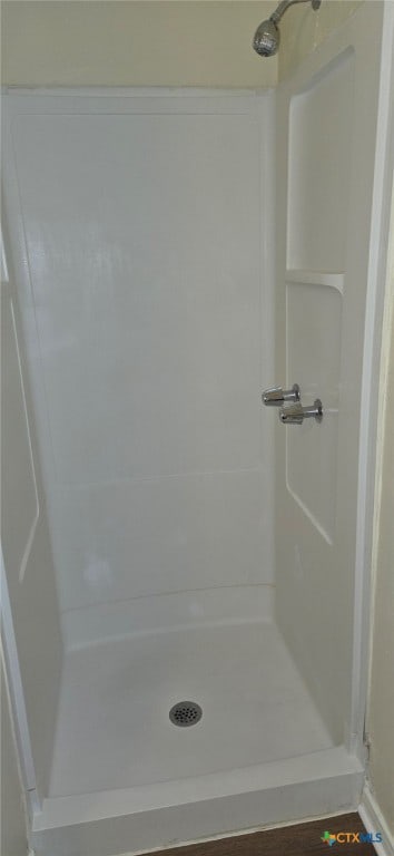 full bath with a shower stall