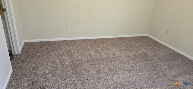 unfurnished room featuring baseboards and carpet flooring