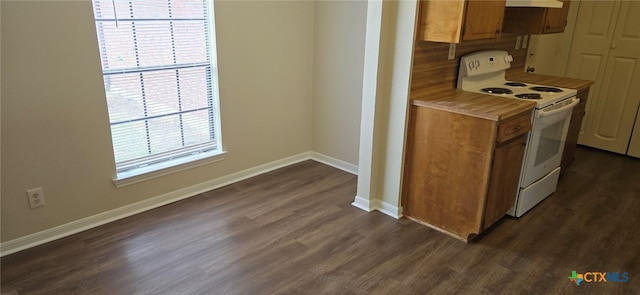 kitchen featuring brown cabinetry, baseboards, dark wood-style flooring, and white range with electric cooktop