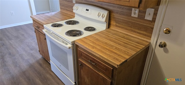 kitchen with electric range, baseboards, dark wood finished floors, and wood counters