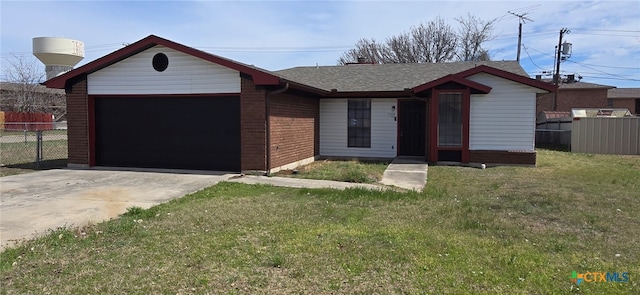 view of front facade with a front lawn, an attached garage, driveway, and fence