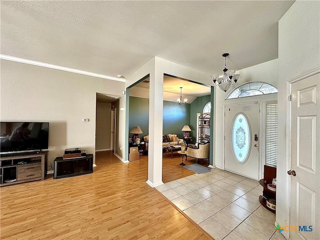entrance foyer featuring a chandelier and light wood-style floors