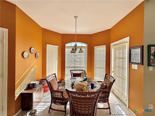 dining area with light tile patterned floors and baseboards