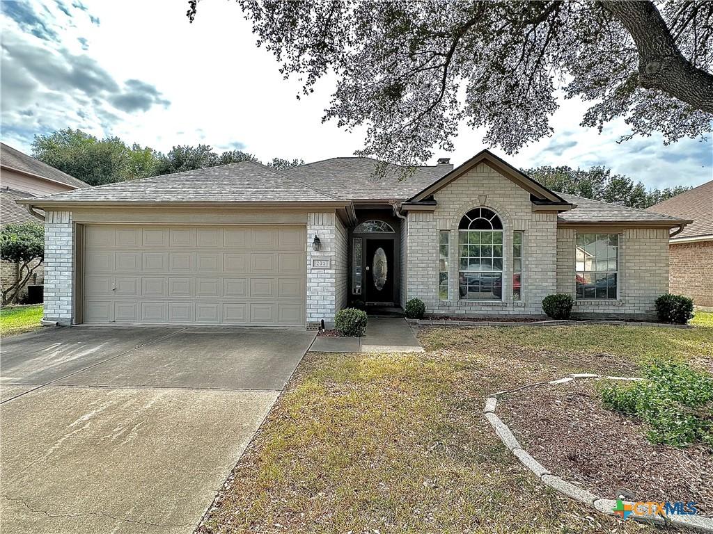 ranch-style home featuring a garage