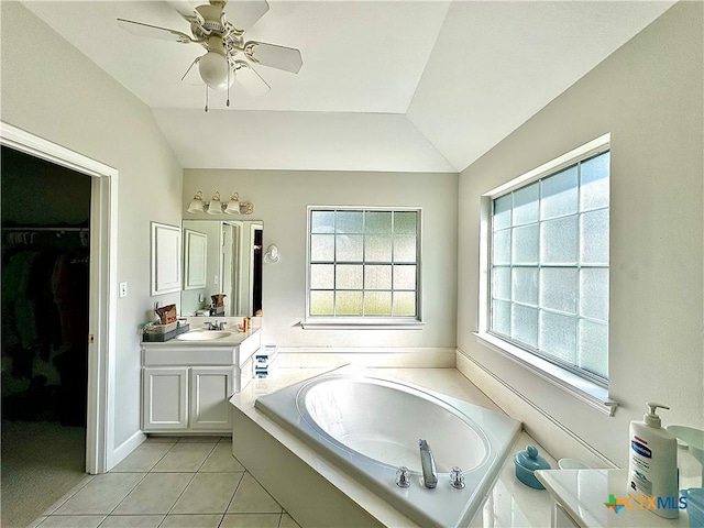 full bathroom featuring vanity, vaulted ceiling, and a healthy amount of sunlight