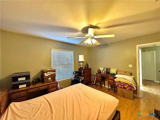 bedroom with a ceiling fan and wood finished floors