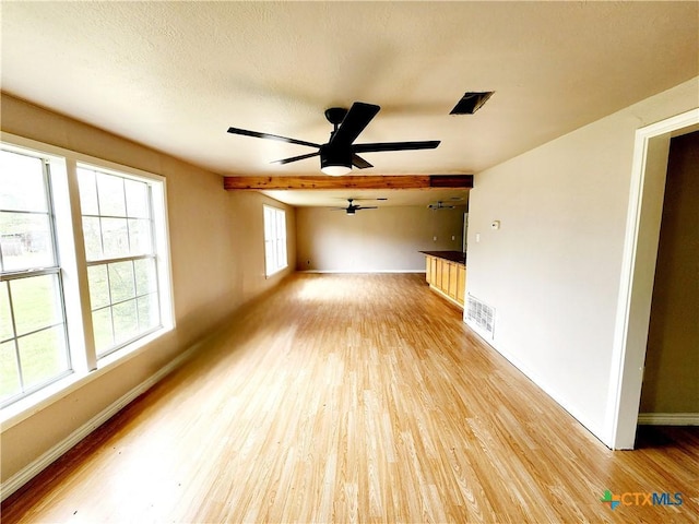 empty room featuring a ceiling fan, light wood-style flooring, and baseboards