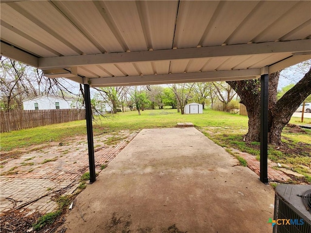 view of patio with central air condition unit, a storage unit, an outdoor structure, and fence