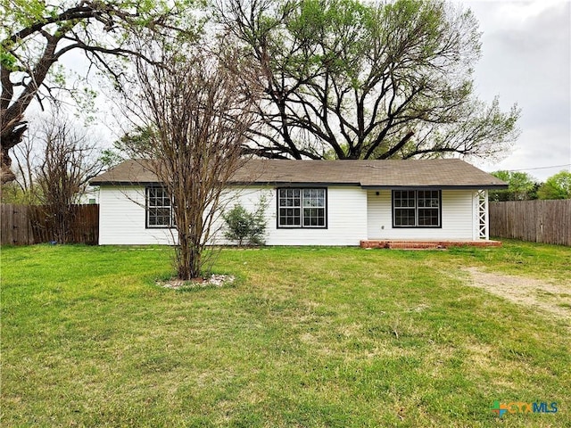 view of front of house with fence and a front yard