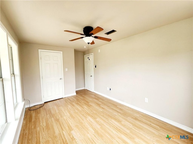unfurnished bedroom featuring light wood-style flooring, baseboards, ceiling fan, and visible vents
