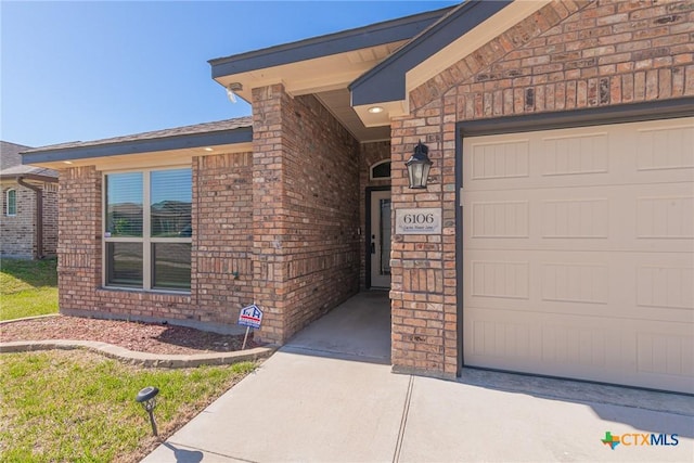 6106 Cactus Flower Ln, Killeen, TX 76549 - doorway to property featuring brick siding and an attached garage