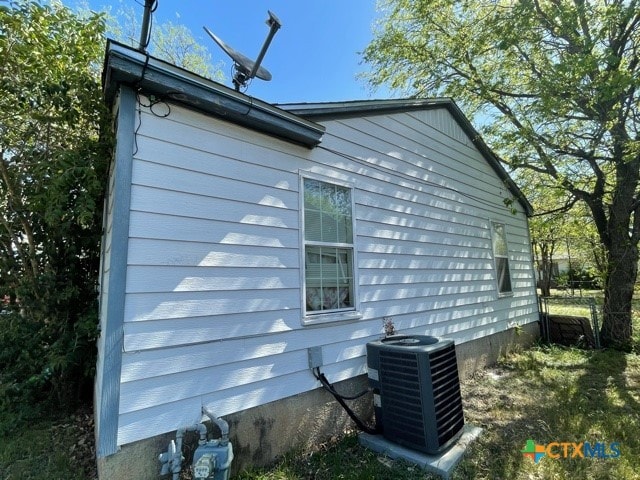 view of side of home featuring cooling unit