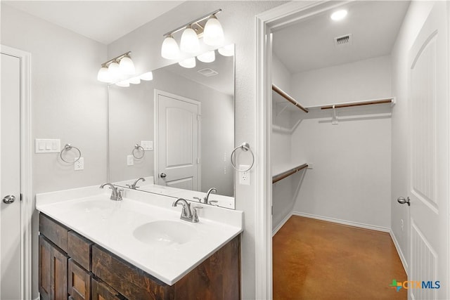 1402 Lindsey Dr, Copperas Cove, TX 76522 - bathroom featuring a sink, a walk in closet, double vanity, and visible vents