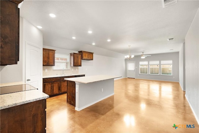 1402 Lindsey Dr, Copperas Cove, TX 76522 - kitchen featuring concrete floors, a sink, visible vents, baseboards, and a kitchen island
