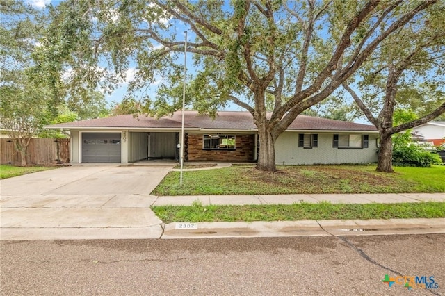 single story home featuring a garage and a front lawn