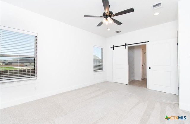 2002 Rosson St, Nolanville, TX 76559 - unfurnished bedroom featuring light colored carpet, recessed lighting, ceiling fan, and a barn door